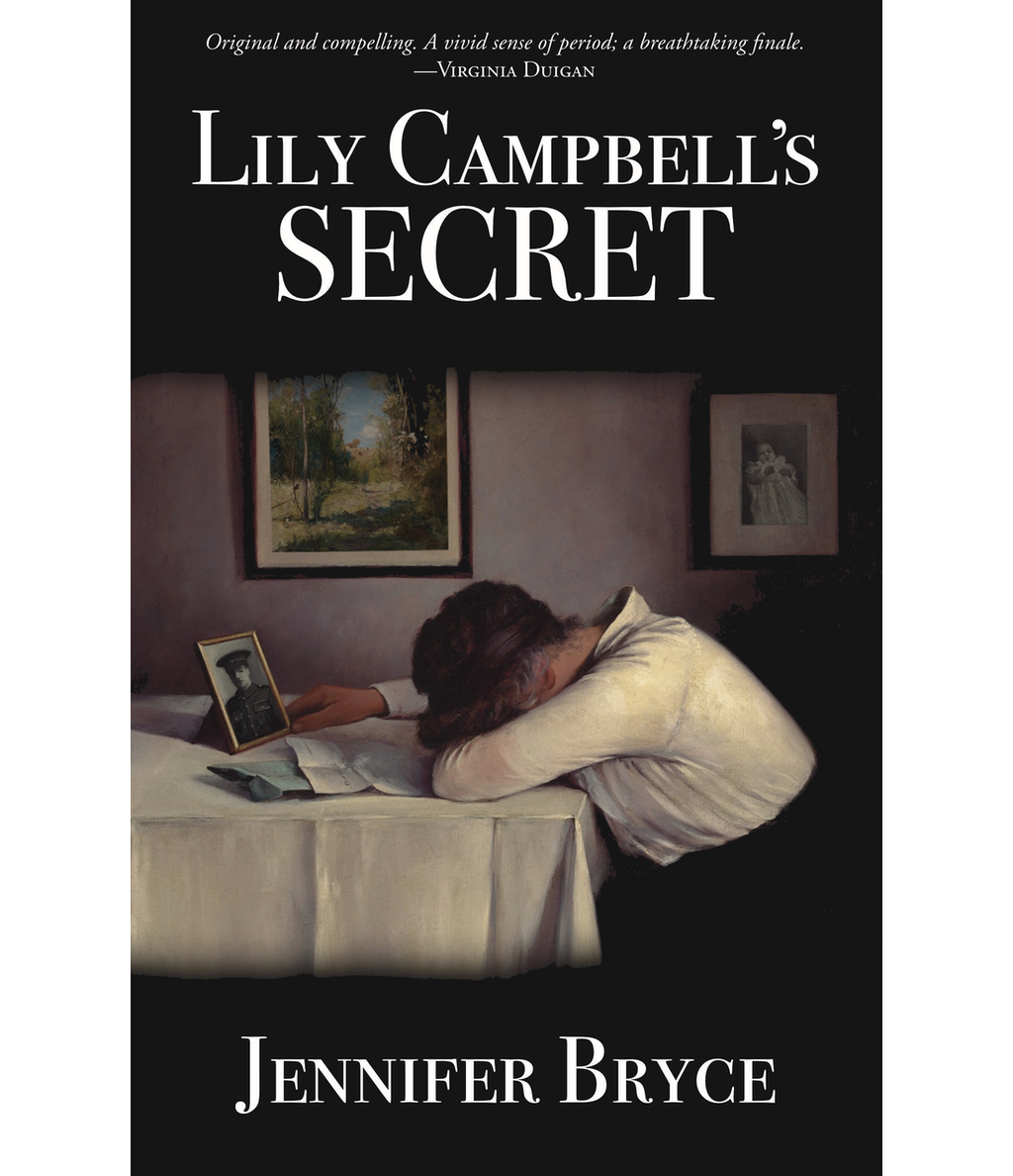 Sorrowing woman leaning on table in front of photo of her husband